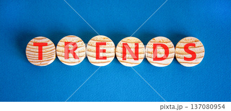 Trends trend word symbol. Concept word Trends on beautiful wooden circles. Beautiful blue background. Business trends trend word concept. Copy space. Trends trend word symbol. Concept word Trends on beautiful wooden circles. Beautiful blue background. Business trends trend word concept. Copy space. 137080954