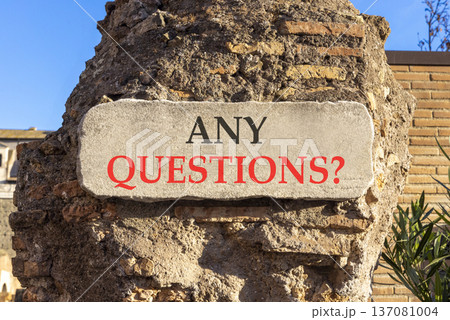 Any questions symbol. Concept words Any questions on beautiful big white sign plate. Beautiful old brown brick wall blue sky background. Business and Any questions Q and A concept, copy space. 137081004