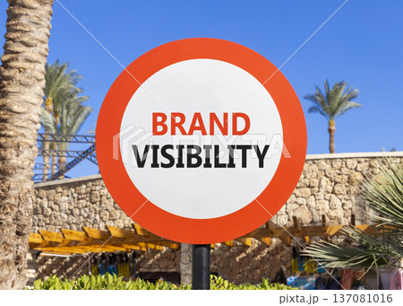 Brand visibility symbol. Concept words Brand visibility on beautiful white road sign. Beautiful blue sky palm trees background. Business branding and brand visibility concept. Copy space. Brand visibility symbol. Concept words Brand visibility on beautiful white road sign. Beautiful blue sky palm trees background. Business branding and brand visibility concept. Copy space. 137081016