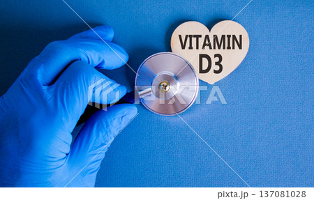 Vitamin D3 symbol. Concept words Vitamin D3 on beautiful wooden heart. Doctor's hand in blue medical glove. Stethoscope. Beautiful blue background. Medical healthy lifestyle Vitamin D3 concept. Vitamin D3 symbol. Concept words Vitamin D3 on beautiful wooden heart. Doctor's hand in blue medical glove. Stethoscope. Beautiful blue background. Medical healthy lifestyle Vitamin D3 concept. 137081028