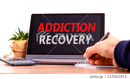 Addiction recovery symbol. Concept words Addiction recovery on beautiful tablet. Psychologist hand. Beautiful wooden table white background. Psychology addiction recovery concept. Copy space. Addiction recovery symbol. Concept words Addiction recovery on beautiful tablet. Psychologist hand. Beautiful wooden table white background. Psychology addiction recovery concept. Copy space. 137081051