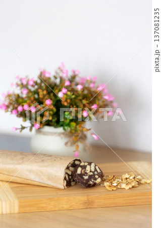 Chocolate salami sausage on wooden board 137081235