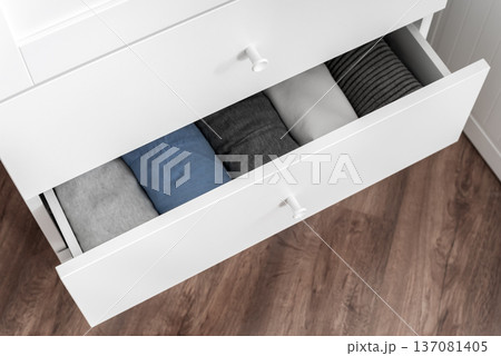 Organized clothes in open white drawer, home storage system Organized clothes in open white drawer, home storage system 137081405