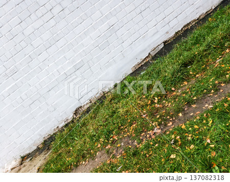 Background of brick wall texture and grass. Background of brick wall texture and grass. 137082318