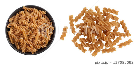 Wolegrain fusilli pasta from durum wheat in ceramic bowl isolated on white background. Top view. Flat lay. Wolegrain fusilli pasta from durum wheat in ceramic bowl isolated on white background. Top view. Flat lay. 137083092