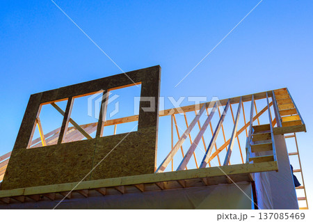 Workers build structure with wooden frames stairs under build wood beam roof trusses structures Workers build structure with wooden frames stairs under build wood beam roof trusses structures 137085469