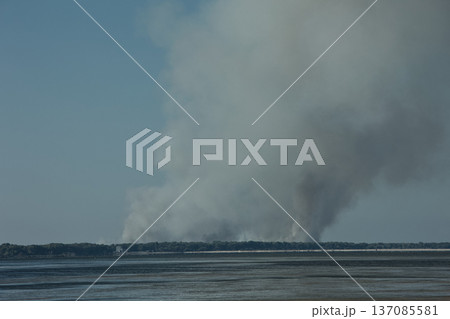 A distant wildfire sends a towering column of smoke into the sky above a small coastal island near Vlora, Albania, captured on August 25, 2025. A distant wildfire sends a towering column of smoke into the sky above a small coastal island near Vlora, Albania, captured on August 25, 2025. 137085581