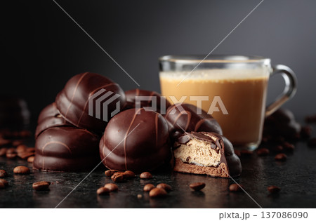 Chocolate dessert and cup of coffee with cream on a black table. Chocolate dessert and cup of coffee with cream on a black table. 137086090