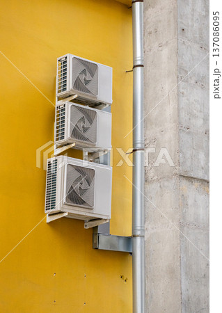 air conditioning on facade of building, air cooling in hot weather. air conditioning on facade of building, air cooling in hot weather. 137086095