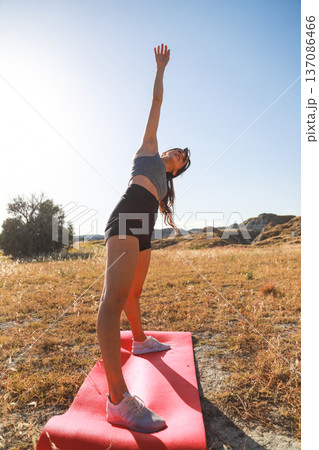 Yoga practice on a pink mat in the mountains 137086466
