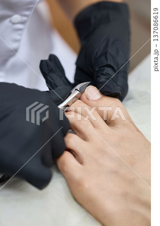 Close-up of pedicure with nail clippers 137086619
