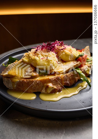 Delicious Eggs Benedict with Smoked Chicken, Fresh Tomato, Creamy Sauce, Crisp Vegetables on Sourdough Bread, Breakfast Culinary Delight Concept Delicious Eggs Benedict with Smoked Chicken, Fresh Tomato, Creamy Sauce, Crisp Vegetables on Sourdough Bread, Breakfast Culinary Delight Concept 137086666