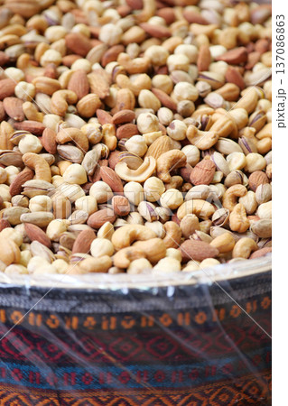 Nuts displayed in a traditional container at a market Nuts displayed in a traditional container at a market 137086863