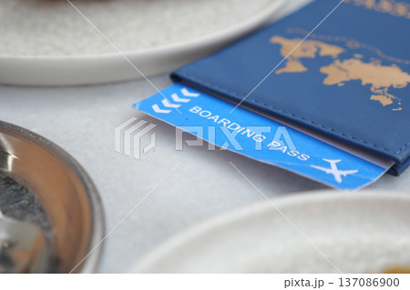 Boarding pass on a table with travel items nearby 137086900