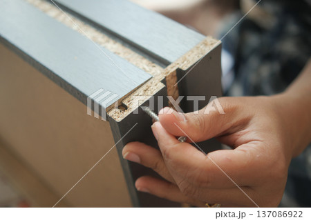 Hand skilled worker assembling furniture parts in workshop Hand skilled worker assembling furniture parts in workshop 137086922