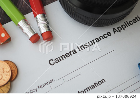 Camera insurance application on table with tools Camera insurance application on table with tools 137086924