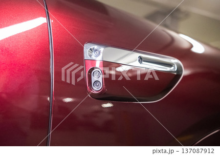 Cameras on the body of a red car.  137087912