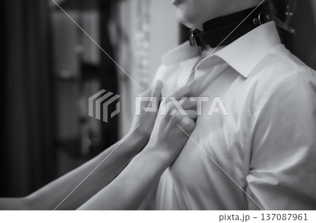 A woman undresses a tied-up man. Role-playing games. A woman undresses a tied-up man. Role-playing games. 137087961