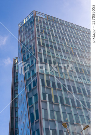 Building towers under blue sky in a city landscape with clear visibility and modern architecture during daylight hours 137089058