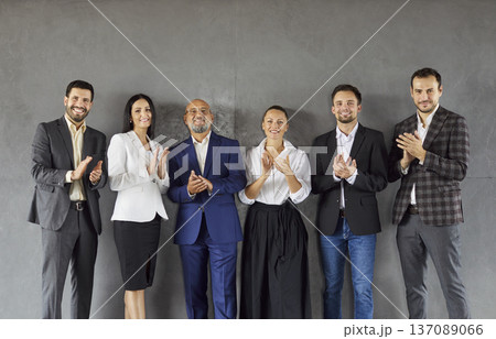 Smiling diverse business team applauding together in modern corporate office 137089066