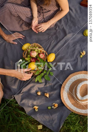 Alfresco dining scene featuring seasonal fruits and stylish attire Alfresco dining scene featuring seasonal fruits and stylish attire 137089354