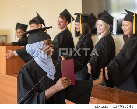 Classmates congratulate African young woman on graduation. Classmates congratulate African young woman on graduation. 137089543