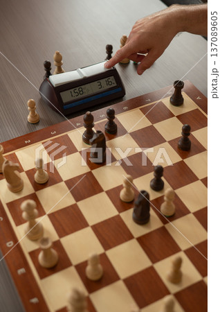 Close up of hands of middle aged caucasian man playing chess.  137089605