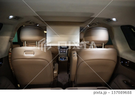 A projector opens in the car's interior for passengers to watch movies. 137089688