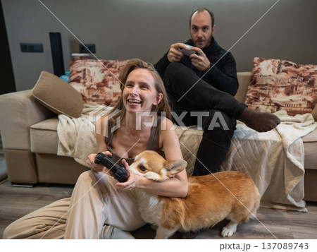 A Caucasian couple playing a video game console.  137089743
