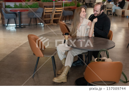 A Caucasian couple on a date in a cafe.  137089744