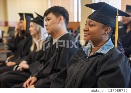 Young people in graduation gowns listen to a...の写真素材 [137089752] - PIXTA