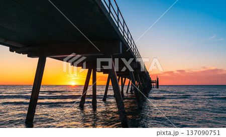Glenelg jetty silhouette at sunset with warm evening colours Glenelg jetty silhouette at sunset with warm evening colours 137090751