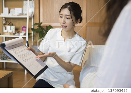 施術前に説明をする鍼灸師 137093435