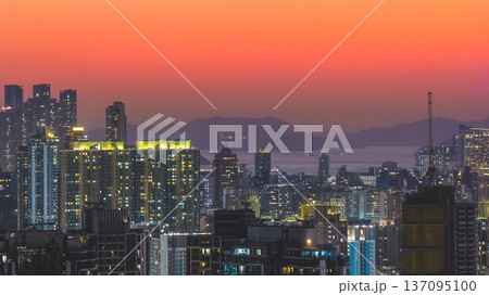 West Kowloon Skyline Glows Warmly Beneath Striking Sunset Gradient Feb 15 2026 137095100