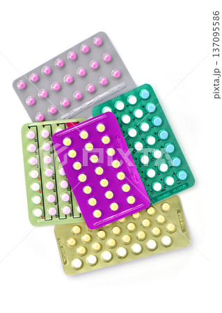 Collection of hormonal birth control pills in different colors and packaging. 137095586