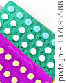 Collection of hormonal birth control pills in different colors and packaging. 137095588