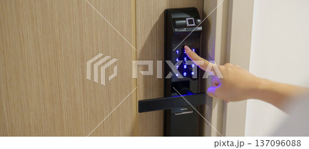 Hand press PIN number for smart digital door lock while open or close the door at home or apartment. NFC Technology, Fingerprint scan, keycard, smartphone and contactless lifestyle concepts Hand press PIN number for smart digital door lock while open or close the door at home or apartment. NFC Technology, Fingerprint scan, keycard, smartphone and contactless lifestyle concepts 137096088