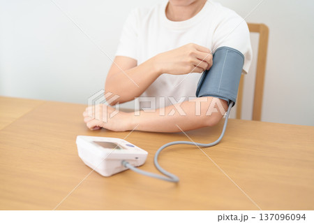 woman checking Blood pressure by Blood pressure monitor with Cuff. Systolic, SYS, Diastolic, DIA, Pulse, Hypertension, Hypotension, Heart rate, Cardiovascular Disease and May World hypertension day woman checking Blood pressure by Blood pressure monitor with Cuff. Systolic, SYS, Diastolic, DIA, Pulse, Hypertension, Hypotension, Heart rate, Cardiovascular Disease and May World hypertension day 137096094