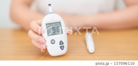 Hand checking Diabetes or Blood glucose self testing by digital blood glucose meter with lancet pen. high blood sugar level, World Diabetes Day, Glycemia, Hypoglycemia, Hyperglycemia and insulin Hand checking Diabetes or Blood glucose self testing by digital blood glucose meter with lancet pen. high blood sugar level, World Diabetes Day, Glycemia, Hypoglycemia, Hyperglycemia and insulin 137096110