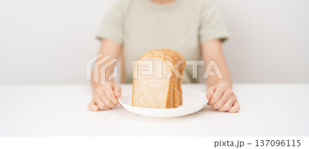 Happy smiling woman with whole wheat bread. Weight loss management, Dieting, Healthy eating, Calorie control, Fitness food, High fiber, Wellness, Lifestyle, Metabolism and Glycemic Index Happy smiling woman with whole wheat bread. Weight loss management, Dieting, Healthy eating, Calorie control, Fitness food, High fiber, Wellness, Lifestyle, Metabolism and Glycemic Index 137096115