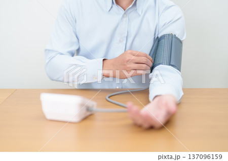 Man checking Blood pressure by Blood pressure monitor with Cuff. Systolic, SYS, Diastolic, DIA, Pulse, Hypertension, Hypotension, Heart rate, Cardiovascular Disease and May World hypertension day Man checking Blood pressure by Blood pressure monitor with Cuff. Systolic, SYS, Diastolic, DIA, Pulse, Hypertension, Hypotension, Heart rate, Cardiovascular Disease and May World hypertension day 137096159