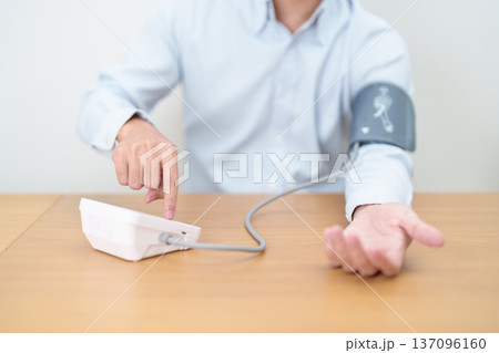 Man checking Blood pressure by Blood pressure monitor with Cuff. Systolic, SYS, Diastolic, DIA, Pulse, Hypertension, Hypotension, Heart rate, Cardiovascular Disease and May World hypertension day Man checking Blood pressure by Blood pressure monitor with Cuff. Systolic, SYS, Diastolic, DIA, Pulse, Hypertension, Hypotension, Heart rate, Cardiovascular Disease and May World hypertension day 137096160