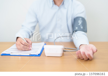 Man checking Blood pressure by Blood pressure monitor with Cuff. Systolic, SYS, Diastolic, DIA, Pulse, Hypertension, Hypotension, Heart rate, Cardiovascular Disease and May World hypertension day Man checking Blood pressure by Blood pressure monitor with Cuff. Systolic, SYS, Diastolic, DIA, Pulse, Hypertension, Hypotension, Heart rate, Cardiovascular Disease and May World hypertension day 137096161