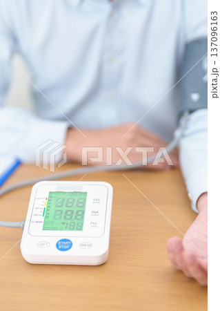 Man checking Blood pressure by Blood pressure monitor with Cuff. Systolic, SYS, Diastolic, DIA, Pulse, Hypertension, Hypotension, Heart rate, Cardiovascular Disease and May World hypertension day Man checking Blood pressure by Blood pressure monitor with Cuff. Systolic, SYS, Diastolic, DIA, Pulse, Hypertension, Hypotension, Heart rate, Cardiovascular Disease and May World hypertension day 137096163