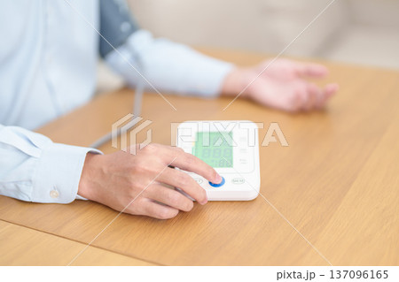 Man checking Blood pressure by Blood pressure monitor with Cuff. Systolic, SYS, Diastolic, DIA, Pulse, Hypertension, Hypotension, Heart rate, Cardiovascular Disease and May World hypertension day Man checking Blood pressure by Blood pressure monitor with Cuff. Systolic, SYS, Diastolic, DIA, Pulse, Hypertension, Hypotension, Heart rate, Cardiovascular Disease and May World hypertension day 137096165
