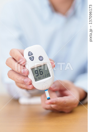 Hand checking Diabetes or Blood glucose self testing by digital blood glucose meter with lancet pen. high blood sugar level, World Diabetes Day, Glycemia, Hypoglycemia, Hyperglycemia and insulin Hand checking Diabetes or Blood glucose self testing by digital blood glucose meter with lancet pen. high blood sugar level, World Diabetes Day, Glycemia, Hypoglycemia, Hyperglycemia and insulin 137096173
