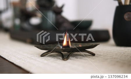 Aroma meditation. Incense burner. Religious tradition fire yoga tools with smoke smoldering on defocused calming background. 137096234