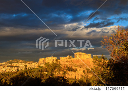 View of the Acropolis Hill, crowned with Parthenon during evening golden hour from the Philopappos Hill in Athens, Greece 137099815