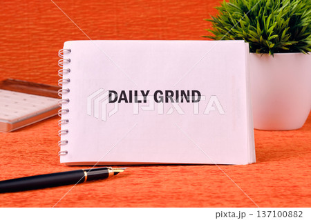 Daily dedication highlighted on a white notepad, poised on an energetic orange desk beside an elegant pen, practical calculator, and a lush potted plant Daily dedication highlighted on a white notepad, poised on an energetic orange desk beside an elegant pen, practical calculator, and a lush potted plant 137100882