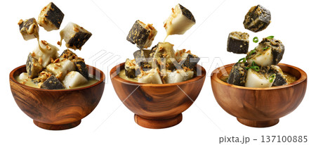 Steamed taro and rice cakes with coconut sauce, scallions, and peanuts in wooden bowl, isolated on white background 137100885